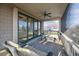 Covered porch showcasing wicker furniture and views of the neighborhood and ocean at 707 Ocean Blvd, Isle of Palms, SC 29451