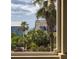 Window view of a neighborhood with lush palm trees and neighboring homes in a coastal community at 707 Ocean Blvd, Isle of Palms, SC 29451