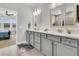 Bathroom with grey vanity, dual sinks, white countertops, wood-look tile, and doorway to bedroom at 733 Spring Highlands Dr, Summerville, SC 29486