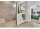 A bathroom with a stone shower, grey tile and glass partition with a connecting view to the bedroom at 733 Spring Highlands Dr, Summerville, SC 29486