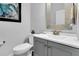 Bathroom featuring a modern gray vanity with a sink and decorative mirror above the toilet at 733 Spring Highlands Dr, Summerville, SC 29486