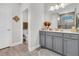 Well-lit bathroom features a gray vanity, large mirror, and an open doorway to the water closet at 733 Spring Highlands Dr, Summerville, SC 29486