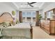This bedroom features a wood bed frame, neutral carpet, large windows and a tray ceiling at 733 Spring Highlands Dr, Summerville, SC 29486