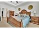 This bedroom features a wood bed frame, neutral carpet, tray ceiling, and two wooden nightstands at 733 Spring Highlands Dr, Summerville, SC 29486