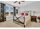 The bedroom has a wrought iron bed frame, floral curtains, tan carpet, and two bedside tables at 733 Spring Highlands Dr, Summerville, SC 29486