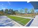 Well-maintained bocce ball courts featuring artificial turf, lighting, and shaded seating areas at 733 Spring Highlands Dr, Summerville, SC 29486