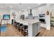 Bright kitchen features a large island with seating, stainless steel appliances, and modern white cabinetry at 733 Spring Highlands Dr, Summerville, SC 29486
