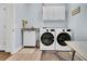 Bright laundry room with modern washer and dryer, sink, ample cabinet space and neutral colors at 733 Spring Highlands Dr, Summerville, SC 29486