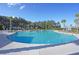 Expansive pool with surrounding lounge areas, umbrellas, and palm trees under a clear blue sky at 733 Spring Highlands Dr, Summerville, SC 29486