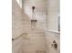 Bathroom shower featuring gray tiling, shower head, mounted hardware, grab bar and built-in shelf at 733 Spring Highlands Dr, Summerville, SC 29486