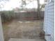 Private, empty backyard with a wooden fence, offering a quiet outdoor space at 7851 Sandida Ct, North Charleston, SC 29418