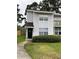 Charming townhouse with a well-maintained lawn and inviting curb appeal at 7851 Sandida Ct, North Charleston, SC 29418