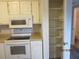 Well-lit kitchen with a white microwave, oven, and pantry at 7851 Sandida Ct, North Charleston, SC 29418