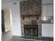 A cozy living room featuring a stone fireplace and built-in shelving at 7851 Sandida Ct, North Charleston, SC 29418
