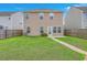 View of the home's backyard featuring a lawn and a stone path leading to the back door at 787 Redbud Ln, Summerville, SC 29486
