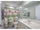 Small bathroom with a colorful shower curtain, grey towel, modern mirror, toilet, and vanity at 787 Redbud Ln, Summerville, SC 29486