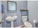 Powder room featuring pedestal sink, framed mirror, and a modern toilet at 787 Redbud Ln, Summerville, SC 29486