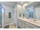 Well lit bathroom with a double sink vanity, white cabinets, and a shower with patterned glass doors at 787 Redbud Ln, Summerville, SC 29486