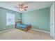 Cozy bedroom with a bed, green walls, white trim, carpet and a ceiling fan for added comfort at 787 Redbud Ln, Summerville, SC 29486