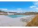 View of community swimming pool with lounge chairs, palm trees, and a clubhouse in the background at 787 Redbud Ln, Summerville, SC 29486