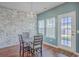 Cozy dining area with a decorative chandelier, exposed brick wall, and natural light at 787 Redbud Ln, Summerville, SC 29486