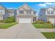 Charming two-story home featuring a two-car garage, manicured lawn, and a welcoming facade at 787 Redbud Ln, Summerville, SC 29486