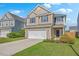 Charming two-story home featuring a two-car garage, manicured lawn, and a welcoming facade at 787 Redbud Ln, Summerville, SC 29486