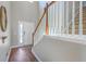 Bright foyer with hardwood floors, staircase, and a decorative mirror, creating a welcoming entrance at 787 Redbud Ln, Summerville, SC 29486