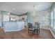 Bright eat-in kitchen features granite countertops, stainless steel appliances, and a decorative brick wall at 787 Redbud Ln, Summerville, SC 29486