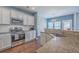 Kitchen featuring granite countertops, stainless steel appliances, a gas range, and white cabinetry at 787 Redbud Ln, Summerville, SC 29486