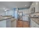 Modern kitchen features stainless appliances, granite counters, white cabinets, and wood flooring at 787 Redbud Ln, Summerville, SC 29486