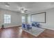Media room with a large screen, comfortable seating, and a ceiling fan for entertainment at 787 Redbud Ln, Summerville, SC 29486