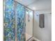 Bathroom stall with sliding floral pattern shower doors, multiple shower heads and a grey towel at 787 Redbud Ln, Summerville, SC 29486
