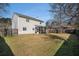 Large backyard with a well-kept lawn, partially fenced, providing ample space for outdoor activities and gatherings at 8005 Old Hazelwood Rd, North Charleston, SC 29406