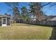 Large backyard with a well-kept lawn and a wooden fence, offering ample space for outdoor activities and privacy at 8005 Old Hazelwood Rd, North Charleston, SC 29406
