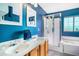 Bright bathroom featuring double sinks, vanity, walk-in shower, and a soaking tub at 8005 Old Hazelwood Rd, North Charleston, SC 29406