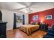 Inviting bedroom with wood floors, natural light, and a large comfortable bed at 8005 Old Hazelwood Rd, North Charleston, SC 29406