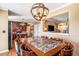 Elegant dining room features a unique light fixture and a large marble-topped table with seating for eight at 8005 Old Hazelwood Rd, North Charleston, SC 29406