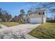 Two-story home features a long driveway, well-manicured lawn, and a two-car attached garage at 8005 Old Hazelwood Rd, North Charleston, SC 29406