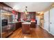 Modern kitchen with stainless steel appliances, dark cabinetry, island, and plenty of counter space at 8005 Old Hazelwood Rd, North Charleston, SC 29406