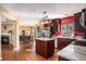 Open-concept kitchen view with stainless steel appliances, dining, living, and fireplace at 8005 Old Hazelwood Rd, North Charleston, SC 29406