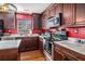 Kitchen with stainless steel appliances, stylish backsplash, and island with breakfast bar at 8005 Old Hazelwood Rd, North Charleston, SC 29406