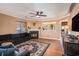 Cozy living room with a decorative fireplace, ceiling fan, and laminate wood flooring at 8005 Old Hazelwood Rd, North Charleston, SC 29406