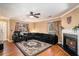 Spacious living room with a fireplace, ceiling fan, laminate floors, and neutral-toned walls at 8005 Old Hazelwood Rd, North Charleston, SC 29406