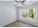 Bedroom with neutral carpet, ceiling fan with light, and window with a view at 8147 Shadow Oak Dr, North Charleston, SC 29406