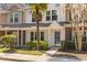 Charming townhome featuring manicured landscaping, a quaint front yard, and a welcoming entryway at 8147 Shadow Oak Dr, North Charleston, SC 29406
