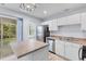 Well-lit kitchen featuring stainless steel appliances, white cabinetry, and a functional center island at 8147 Shadow Oak Dr, North Charleston, SC 29406