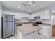 Well-lit kitchen featuring stainless steel appliances, white cabinetry, and a functional center island at 8147 Shadow Oak Dr, North Charleston, SC 29406