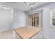 Eat-in kitchen with a sliding glass door and tan countertops on the island, along with white cabinets at 8147 Shadow Oak Dr, North Charleston, SC 29406