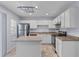 Well-lit kitchen featuring stainless steel appliances, white cabinetry, and a functional center island at 8147 Shadow Oak Dr, North Charleston, SC 29406